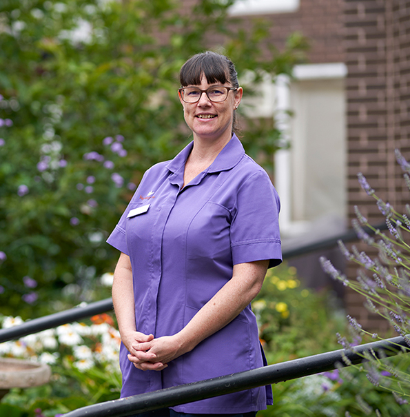 Nurse Associate standing in garden - Westward Care