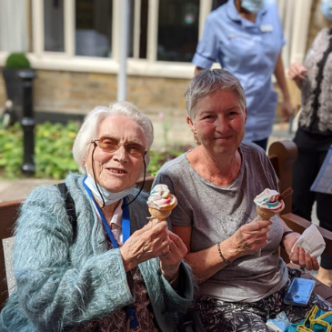 Residents enjoying an ice cream in the sunshine