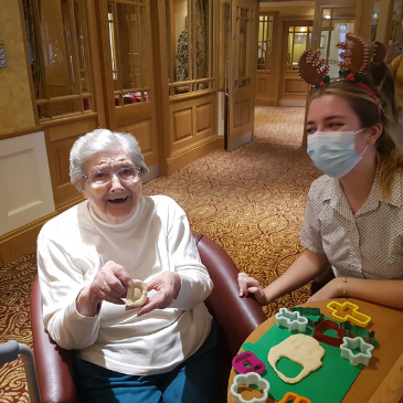 Our residents at Headingley Hall making salt dough decorations to hang on the Christmas tree.  One of our residents is showing off the D she made for Denise, our receptionist at Headingley Hall.
