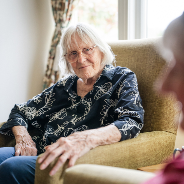 Older woman sat in armchair